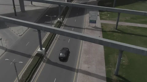 The drone shoots the movement of the car on a road Stock Footage 215516665