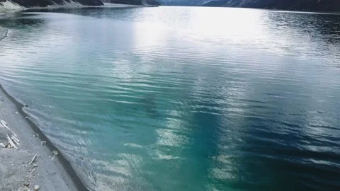 Drone shoots soft waves caressing the bank of transparent Muncho Lake in Alberta Video stock 139118558