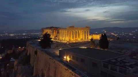Drone shot in 4k over illuminated Athens Acropolis Parthenon at night Stock Footage