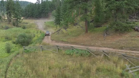 Drone shot of 4x4 UTV, ATV, driving off-road through a forest and hills Stock Footage 303064477