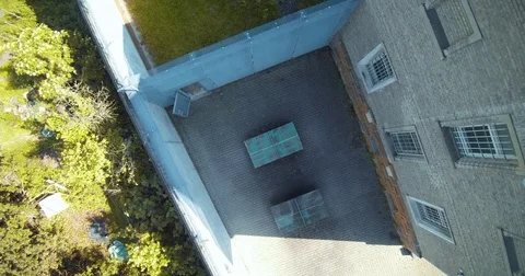 Drone shot of an abandoned prisons table tennis plates (lost places) 動画素材 79602756