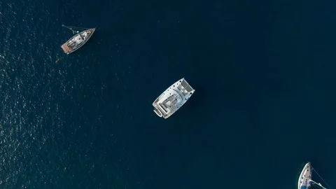 Drone shot from above as the camera descends to a huge yacht Видео 119438306