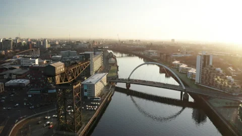 A drone shot above the river clyde of the Squigly Bridge in Glasgow Stock-Footage 132925616