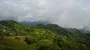Drone shot aerial curve jungle mountains village buildings beautiful Indonesia 4k or 4k+ Resolution