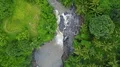 Drone shot aerial descend rock waterfall in tropic palm tree rainforest Bali 4k 4k or 4k+ Resolution