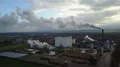 Drone shot aerial descent sugar factory with smoking chimney at sunny autumn day 4k or 4k+ Resolution