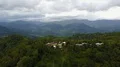 Drone shot aerial fly over small hidden village on jungle mountain peak 4k or 4k+ Resolution