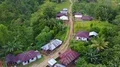 Drone shot aerial jungle mountain village buildings and ricefield Indonesia 4k or 4k+ Resolution