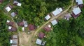 Drone shot aerial jungle mountains and village buildings and graveyard Indonesia 4k or 4k+ Resolution