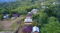 Drone shot aerial jungle mountains and village buildings beautiful Indonesia 4k or 4k+ Resolution