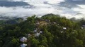 Drone shot aerial jungle mountains and village above clouds in Indonesia 4k or 4k+ Resolution