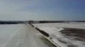 Drone shot aerial over snow-white frozen countryside farmland field 4k 4k or 4k+ Resolution