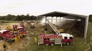 Drone Shot Of Aerial Pumper Fire Truck Fighting Hay Shed Fire. Stock Footage