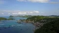 Drone shot aerial small town harbor and forest mountain in foreground 4k or 4k+ Resolution