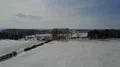 Drone shot aerial snow-white frozen countryside farmland and street traffic 4k or 4k+ Resolution