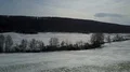 Drone shot aerial snow-white low mountain range valley in winter with tree line 4k or 4k+ Resolution