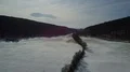 Drone shot aerial snow-white low mountain range valley in winter with tree line 4k or 4k+ Resolution