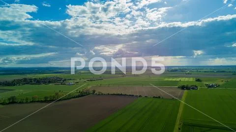 Drone shot aerial springtime countryside farmland landscape beautiful day Stock Photos