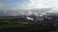 Drone shot aerial sugar factory with smoking chimney at sunny autumn day 4k or 4k+ Resolution