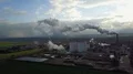 Drone shot aerial sugar factory with smoking chimney at sunny autumn day 4k or 4k+ Resolution
