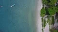 Drone shot aerial top view tropic white sand beach with trees and boats on sea 4k or 4k+ Resolution