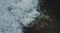 Drone shot aerial top view flyover foamy sea water waves coastline reef Bali 4k or 4k+ Resolution