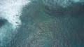 Drone shot aerial top view flyover foamy sea water waves coastline reef Bali 4k or 4k+ Resolution