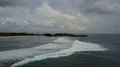 Drone shot aerial tropic beach and foamy seashore waves tourism paradise Bali 4k or 4k+ Resolution