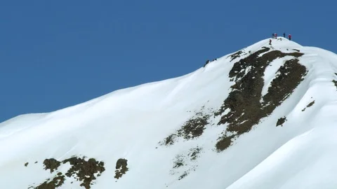 Drone shot from afar of freeride skier shredding big mountain with blue sky Stock Footage 124227789