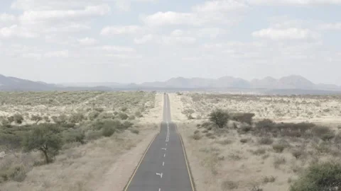 Drone shot along single road in rural Namibia 스톡 동영상 244706547