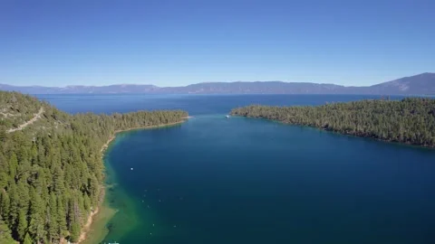 Drone Shot of Alpine Bay Expanding into Vast Mountain Lake Видео 334695849