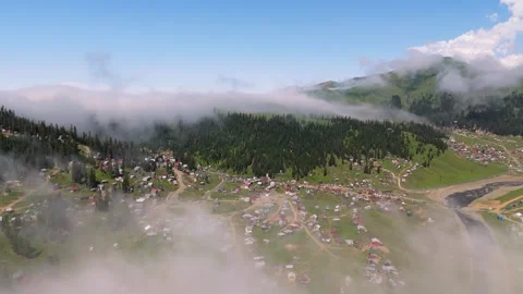 Drone shot of an alpine village in the clouds in sunny weather Stock Footage 298536149