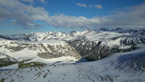 Drone shot approaching mountain edge with view of deep valley and mountains Stock Footage 124226127