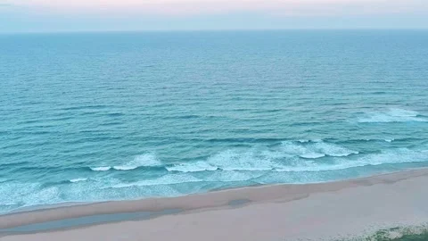 Drone shot approaching shoreline at sunset, tilt Stock Footage 304267420