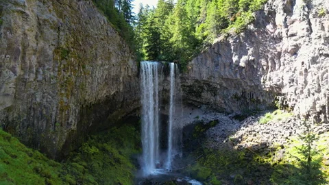 Drone shot approaching waterfall with hikers and torists in the forest Stock Footage 248927478