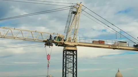Drone Shot Ascending and Pulling Back Revealing a Tower Crane Overlooking the Stock Footage 318954281