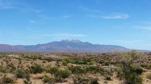 Drone shot backwards over dry prairie of Arizona with the Four peaks in Stock Footage 240831026