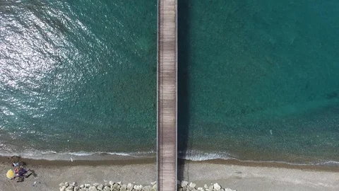 Drone shot of beach extending to pier revealing the sky Stock Footage 88197342