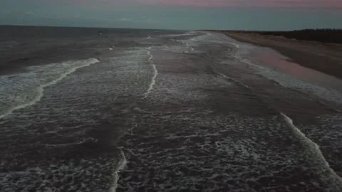 Drone shot of beach waves at sunset Stock Footage 220515304