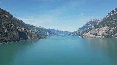 A drone shot of a beautiful lake located in the middle of high mountains. Stock Footage 249976232