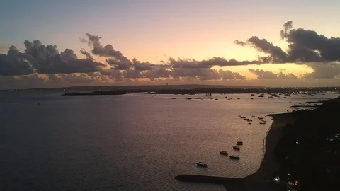 Drone shot of beautiful sunset with red and orange sky along the beach Stock Footage