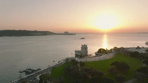 Drone Shot of Belém Tower during Sunset with a warship passing by Stock Footage 184493407