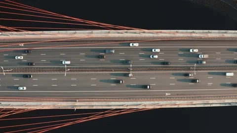 Drone shot of a big bridge with river, many cars moving on multi-lane road Видео 145134323