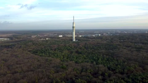 Drone shot of big broadcast tower in forest in Hilversum with blue sky Stock Footage 147203500