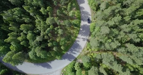 Drone shot of a biker driving up Grefsenkollen in Oslo, Norway, with car Stock Footage 71297366
