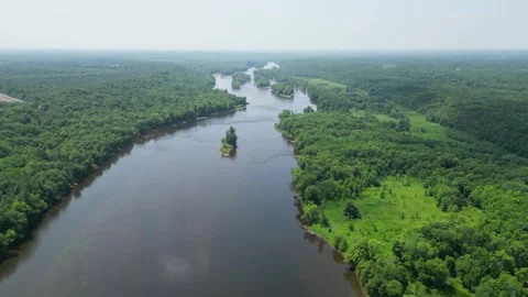 Drone Shot of Blue River with Trees Along Shoreline with Green Forest Landscape Stock Footage 244958755