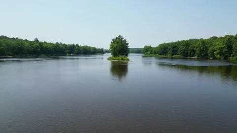 Drone Shot of Blue River with Trees Along Shoreline with Green Forest Landscape Stock Footage 244958989