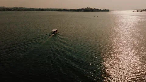 Drone Shot of Boat at Sunset on Lago Petén Itzá, Flores Island, Petén, Guatemala Stock Footage 340333563