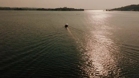 Drone Shot of Boat at Sunset Over Lago Petén Itzá, Flores Island, Guatemala Stock Footage 340036374