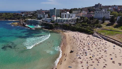 Drone shot of Bondi Beach, showcasing people swimming, sunbathing, and relaxing Stock Footage 301065013